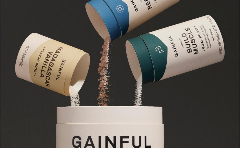 Three Gainful protein accessory powders being poured into a Gainful protein jar