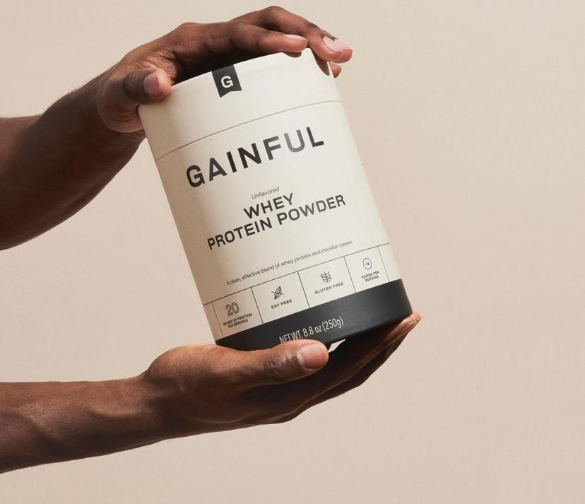 Two hands shaking a jar of Gainful protein powder